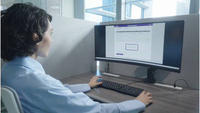 Photo of a woman working on a PC, representing easy and efficient deployment
