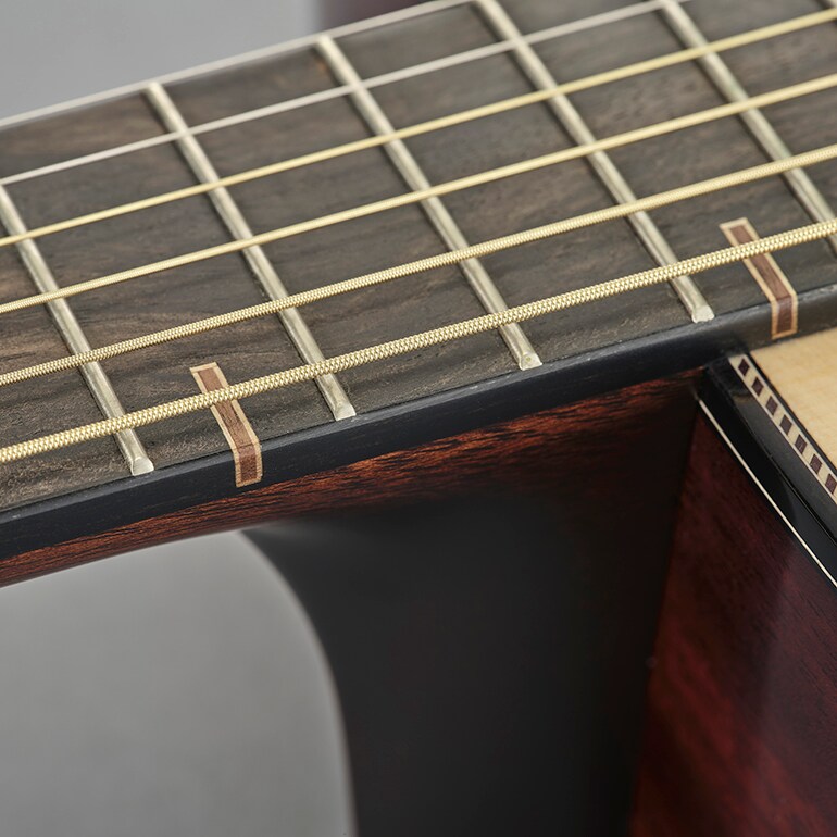 Close-up of a wooden fingerboard inlay inspired by traditional Japanese Kumiki woodworking.