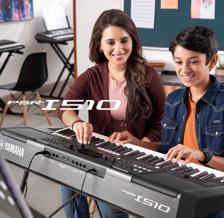 An instructor teaching the keyboard in a music class, and students performing on the PSR-I510